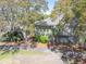 Charming home nestled among mature trees with lattice siding and tropical landscaping at 754 Summerwind Cir, Edisto Island, SC 29438