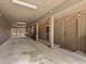 Spacious covered garage area featuring a concrete floor, lattice wall, and convenient access door at 754 Summerwind Cir, Edisto Island, SC 29438