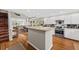 Bright, open kitchen with stainless steel appliances, white cabinets, hardwood floors and seamless living room access at 754 Summerwind Cir, Edisto Island, SC 29438