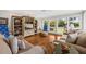 Inviting living room featuring a comfortable sofa, built-in shelving, and plenty of natural light at 754 Summerwind Cir, Edisto Island, SC 29438
