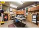 Large storage room with ample workspace, cabinets, pegboard, and overhead lighting at 754 Summerwind Cir, Edisto Island, SC 29438