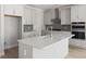 Modern kitchen featuring white cabinets, stainless steel appliances, and a large center island at 757 Maynard Ln, Summerville, SC 29486