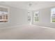 Bright main bedroom featuring neutral carpet, large windows, and plenty of space for furniture at 757 Maynard Ln, Summerville, SC 29486