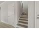 Staircase with white risers, wood treads and white walls leads to upper level of home at 757 Maynard Ln, Summerville, SC 29486