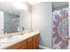 Bathroom featuring a double sink vanity, large mirror, and a shower/tub combo with colorful curtain at 7873 Park Gate Dr, North Charleston, SC 29418