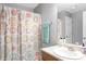 Clean bathroom featuring neutral walls, a sink vanity, and a shower/tub combo with patterned curtain at 7873 Park Gate Dr, North Charleston, SC 29418