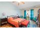 Bright bedroom featuring an iron frame bed, hardwood floors, and colorful decor throughout at 7873 Park Gate Dr, North Charleston, SC 29418
