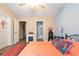 Bedroom featuring hardwood floors, closet and bathroom access, and an iron frame bed at 7873 Park Gate Dr, North Charleston, SC 29418