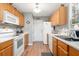 Efficient kitchen with oak cabinets and white appliances, ready for culinary adventures at 7873 Park Gate Dr, North Charleston, SC 29418