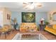 Bright living room with ceiling fan and tapestry offering a cozy gathering space at 7873 Park Gate Dr, North Charleston, SC 29418