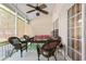 Covered back patio with wicker furniture, ceiling fan, and privacy shades at 7873 Park Gate Dr, North Charleston, SC 29418