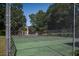 A community tennis court is fenced and has trees in the background, offering a convenient recreational amenity at 7921 Cricket Ct # D, North Charleston, SC 29418