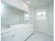 Bathroom featuring double sink vanity, white marble countertops and a large, frameless mirror and natural light at 806 Kings Oak Court Ct # 7, Charleston, SC 29492