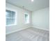 Bright bedroom featuring plush carpet and two large windows providing plenty of natural light at 806 Kings Oak Court Ct # 7, Charleston, SC 29492