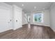 Spacious living area featuring hardwood floors, large windows, and access to the stairway at 806 Kings Oak Court Ct # 7, Charleston, SC 29492