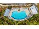 Aerial view of a community pool with lounge chairs, palm trees, and shade structures at 806 Kings Oak Court Ct # 7, Charleston, SC 29492