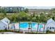 Community pool surrounded by palm trees, lounge chairs, and lush greenery, with views of the marsh at 806 Kings Oak Court Ct # 7, Charleston, SC 29492