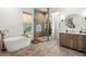 Beautiful bathroom with soaking tub, stone shower, and natural light at 8067 Jack Island Dr, Johns Island, SC 29455