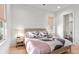 Bright bedroom with wood floors, windows, and a view to the bathroom at 8067 Jack Island Dr, Johns Island, SC 29455