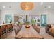 Bright dining area features a large wooden table with seating for eight and a view of the outdoor patio at 8067 Jack Island Dr, Johns Island, SC 29455