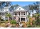 Charming two-story home with a covered front porch and landscaped yard, perfect for relaxing or entertaining at 8067 Jack Island Dr, Johns Island, SC 29455