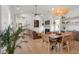 Bright living room and dining area featuring hardwood floors, neutral tones, and modern lighting at 8067 Jack Island Dr, Johns Island, SC 29455