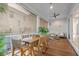 Inviting screened-in porch with wood table, seating, ceiling fan, and neighborhood views at 8067 Jack Island Dr, Johns Island, SC 29455