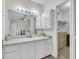Well-lit bathroom featuring vanity and storage with a large mirror and access to a walk-in closet at 8219 Quail Hollow Ct, North Charleston, SC 29420