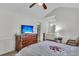 Bedroom with a TV on a wooden dresser, a ceiling fan, and a view to the ensuite bathroom at 8219 Quail Hollow Ct, North Charleston, SC 29420