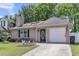 Charming single-story home featuring a well-manicured lawn and an inviting green front door at 8219 Quail Hollow Ct, North Charleston, SC 29420