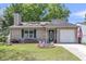 Charming single-story home featuring a well-manicured lawn and an inviting green front door at 8219 Quail Hollow Ct, North Charleston, SC 29420