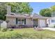 Charming single-story home featuring a well-manicured lawn and an inviting green front door at 8219 Quail Hollow Ct, North Charleston, SC 29420