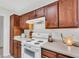 A kitchen showcasing a white oven range with classic cabinets and a clean countertop at 8219 Quail Hollow Ct, North Charleston, SC 29420