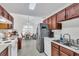 Well-lit eat-in kitchen featuring stainless steel appliances and cherry wood cabinets under a skylight at 8219 Quail Hollow Ct, North Charleston, SC 29420
