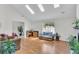 Bright living room featuring hard wood floors, skylights, and ample seating at 8219 Quail Hollow Ct, North Charleston, SC 29420