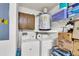 A utility room with washer, dryer, water heater, storage and shelving in a well-lit space at 8219 Quail Hollow Ct, North Charleston, SC 29420