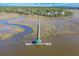 Stunning aerial view of dock and waterside community with mature landscaping at 8551 Pope Landing Rd, Edisto Island, SC 29438