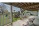 Relaxing covered porch with stairs, hammock, and open gate leading to the yard at 8551 Pope Landing Rd, Edisto Island, SC 29438