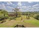 Lush backyard featuring expansive green space and mature trees with views of the marsh at 8551 Pope Landing Rd, Edisto Island, SC 29438