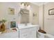 Bathroom featuring a white vanity, stained toilet seat, and framed vanity mirror at 8551 Pope Landing Rd, Edisto Island, SC 29438