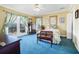 Bedroom with blue carpet, ceiling fan, doorway to deck with view, and classic furniture at 8551 Pope Landing Rd, Edisto Island, SC 29438