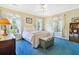 Comfortable bedroom with sunny windows, bright carpet, ceiling fan, and classic furniture at 8551 Pope Landing Rd, Edisto Island, SC 29438