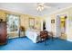 Bedroom featuring blue carpet, sunny windows, a ceiling fan, and a closet at 8551 Pope Landing Rd, Edisto Island, SC 29438