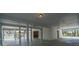 Large covered parking area with a white support beams and secure storage area at 8551 Pope Landing Rd, Edisto Island, SC 29438