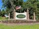 Community entrance sign with an American flag and manicured landscape at 8551 Pope Landing Rd, Edisto Island, SC 29438
