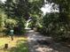 Community entrance through a wooded area, offering seclusion and privacy at 8551 Pope Landing Rd, Edisto Island, SC 29438