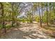 Beautiful home surrounded by mature trees and landscaping, as seen from the gated driveway at 8551 Pope Landing Rd, Edisto Island, SC 29438