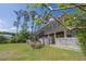 Charming home exterior featuring a screened porch, stairs, and a well-maintained yard at 8551 Pope Landing Rd, Edisto Island, SC 29438