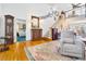 Inviting living room featuring hardwood floors, staircase, and doorway leading to a bedroom with a blue carpet at 8551 Pope Landing Rd, Edisto Island, SC 29438