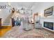 Bright living room with soaring ceilings, a fireplace, and a staircase to a loft at 8551 Pope Landing Rd, Edisto Island, SC 29438